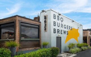 The iconic exterior of The Pioneer BBQ, inspiring you to bring their flavorful barbecue to your next backyard gathering.