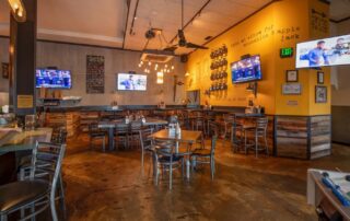 The warm and inviting dining room at The Pioneer BBQ, ideal for hosting large group gatherings.